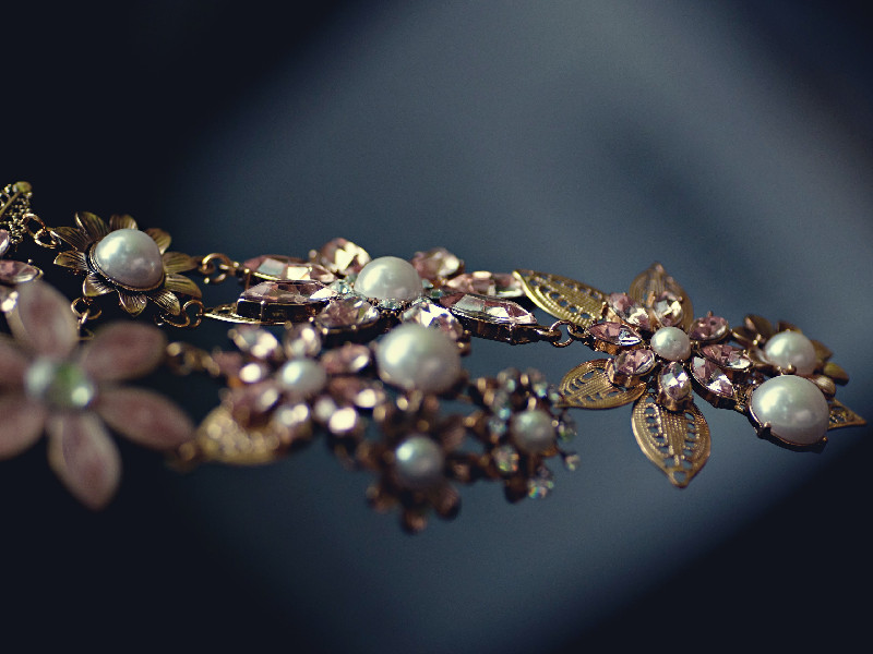 Close-up photo of a broach with pink flower design